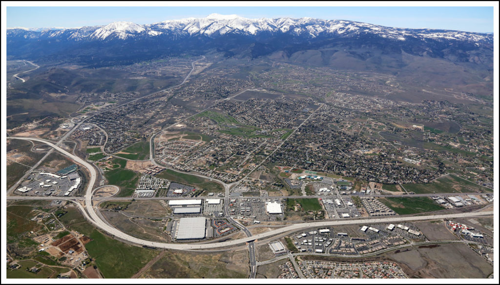 Shopping center aerial with wide sweeping views of residential neighborhoods nearby